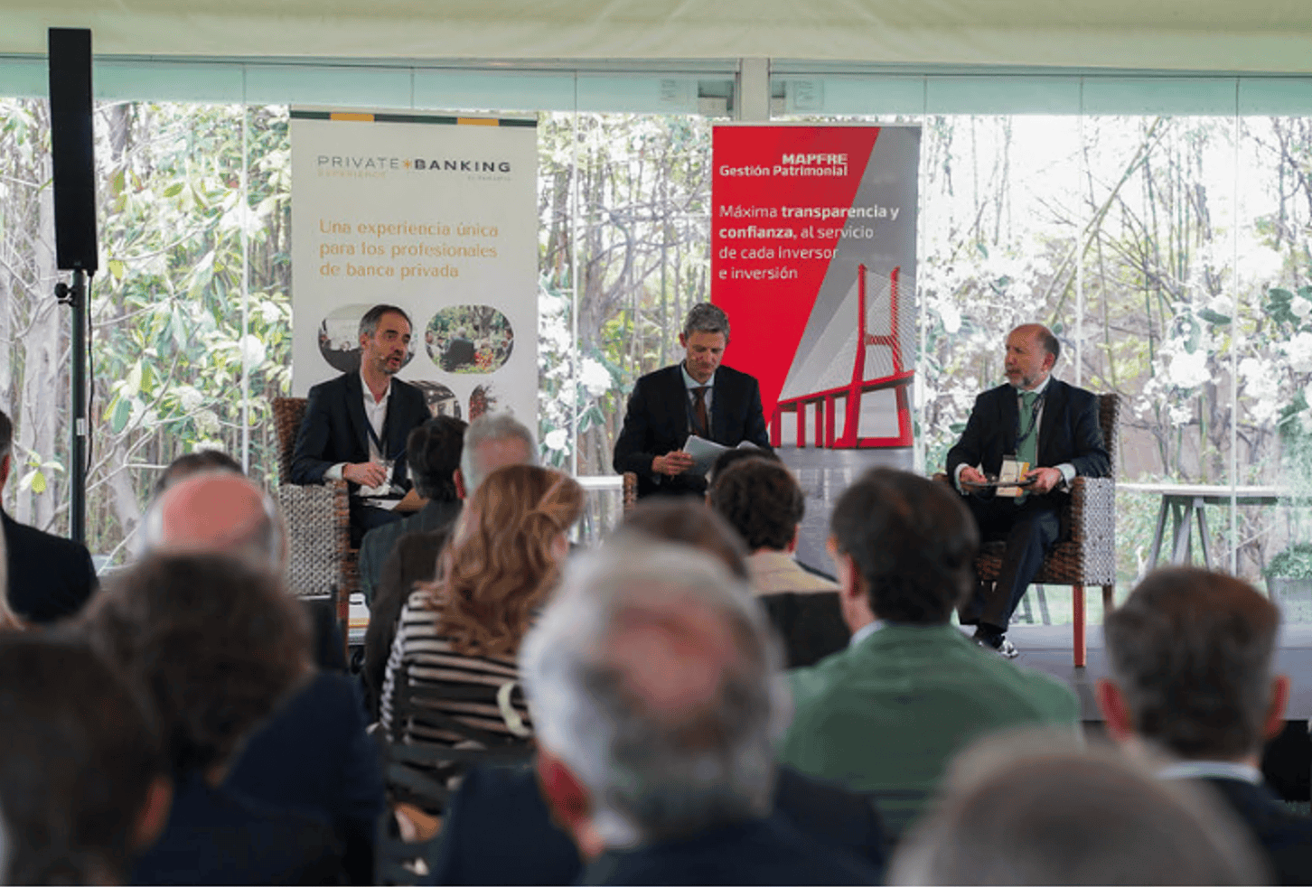 Para esta imagen de mesa redonda con público en el invernadero: Texto alternativo (ALT) Mesa redonda del evento RankiaPro en el invernadero de La Quinta de Illescas con asistentes escuchando a los ponentes